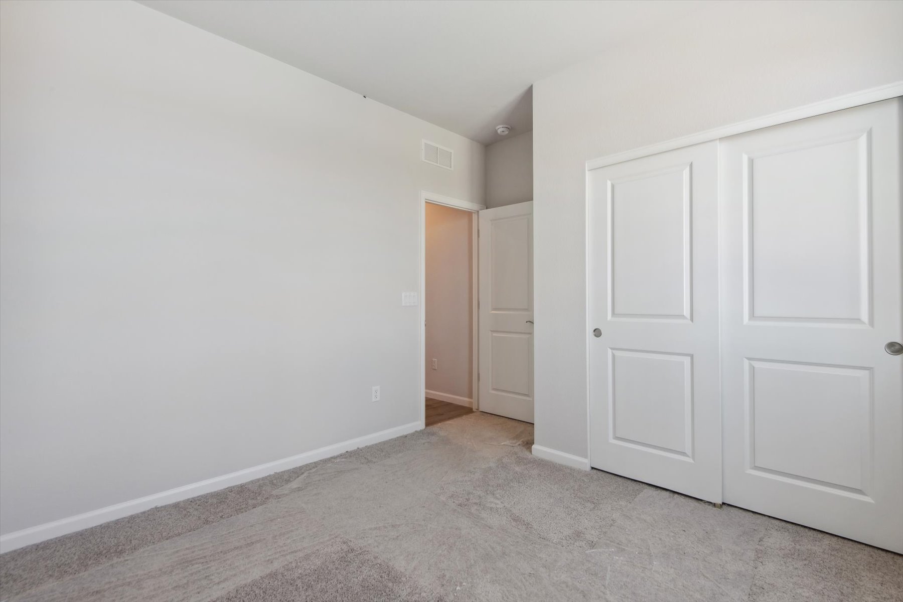 A hallway with white doors.
