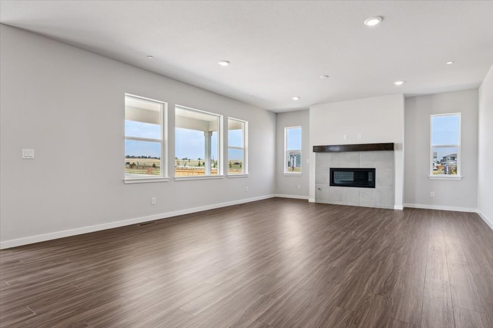 A large empty room with a fireplace.