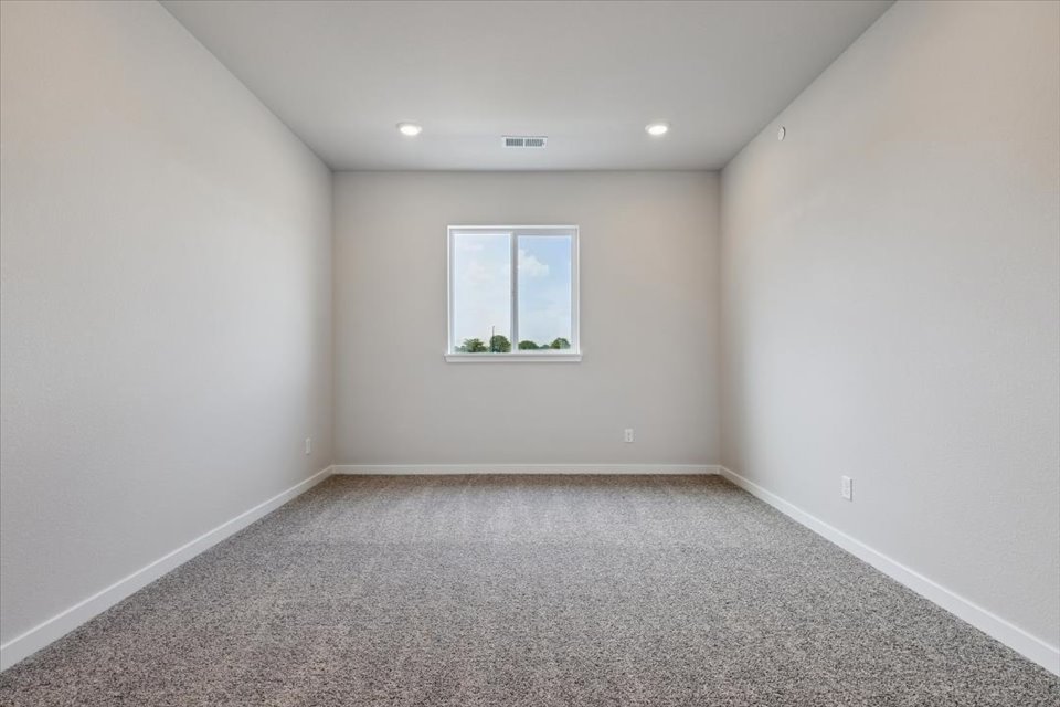 A room with a window and a plant in it.