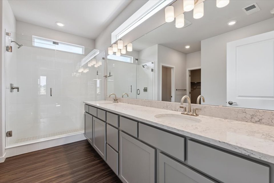 A bathroom with a large mirror.