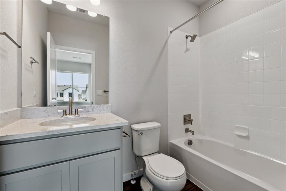 A bathroom with a toilet sink and bathtub.