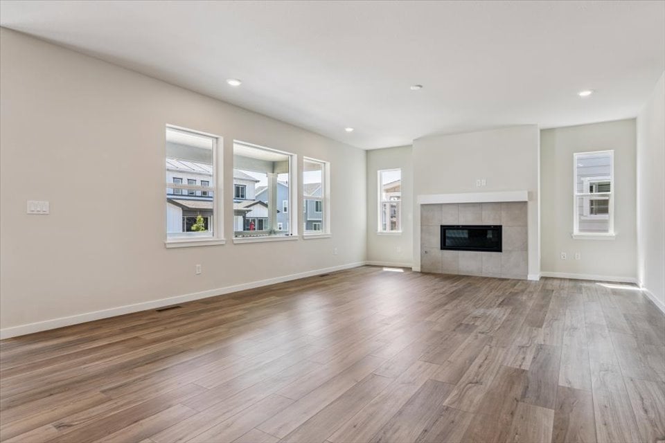A large empty room with a fireplace.