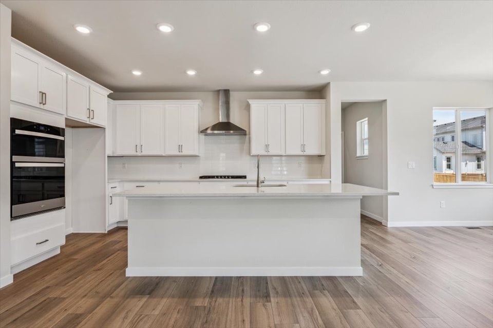 A kitchen with white cabinets.