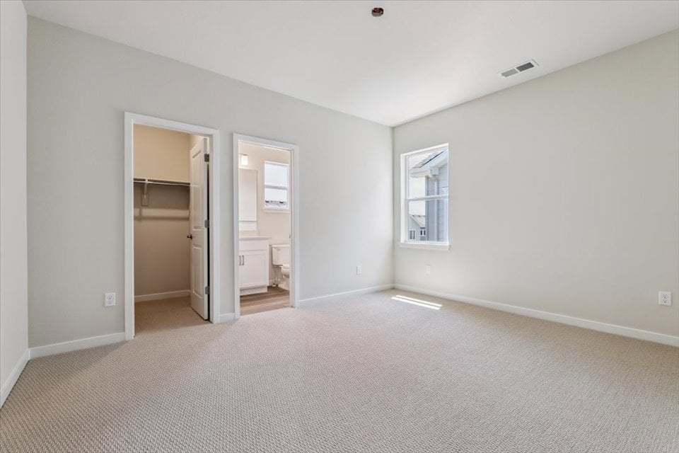 A room with a carpet and a door.