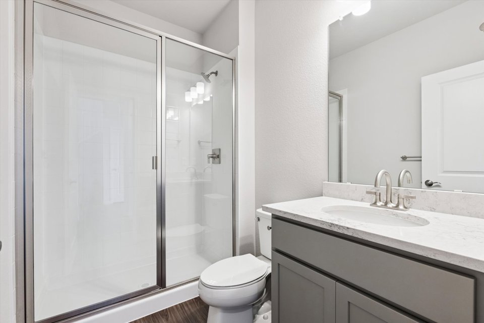 A bathroom with a glass shower.