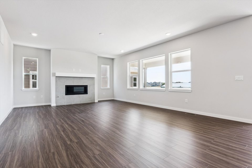 A large empty room with a fireplace.
