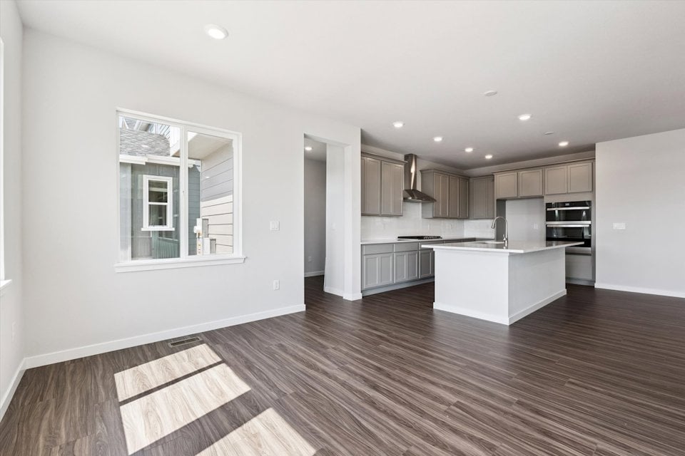 A kitchen with white walls.