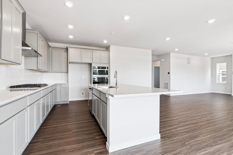 A kitchen with white cabinets.