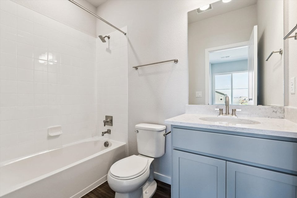 A bathroom with a tub toilet and sink.