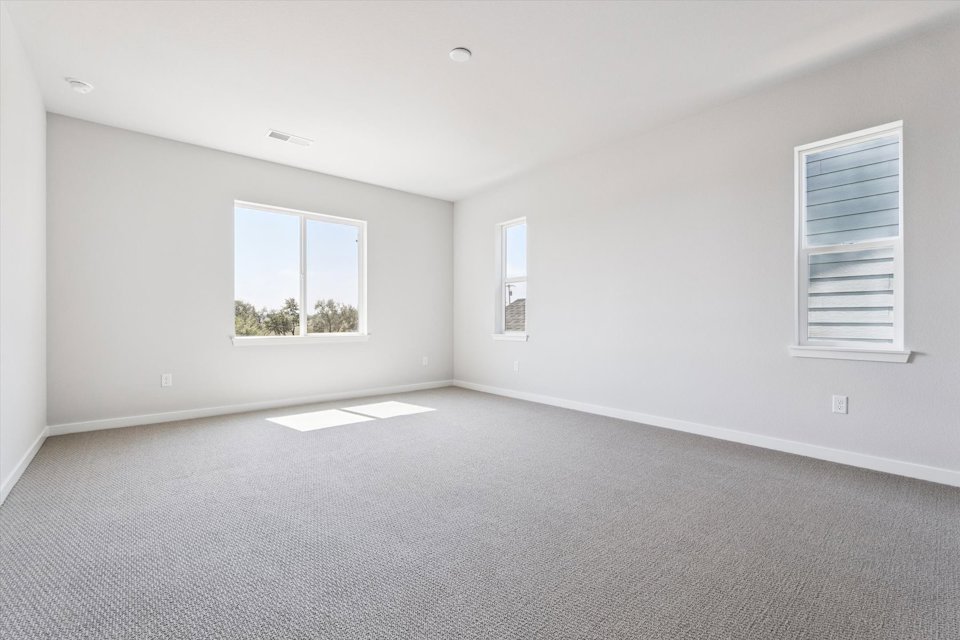 A room with a window and a carpet.