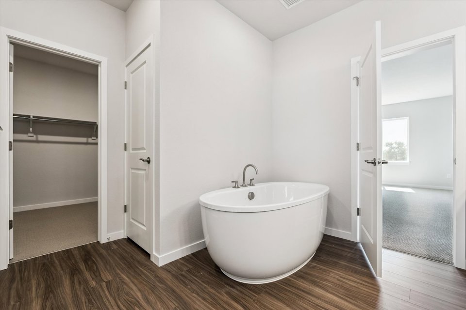 A bathroom with a tub and a sink.
