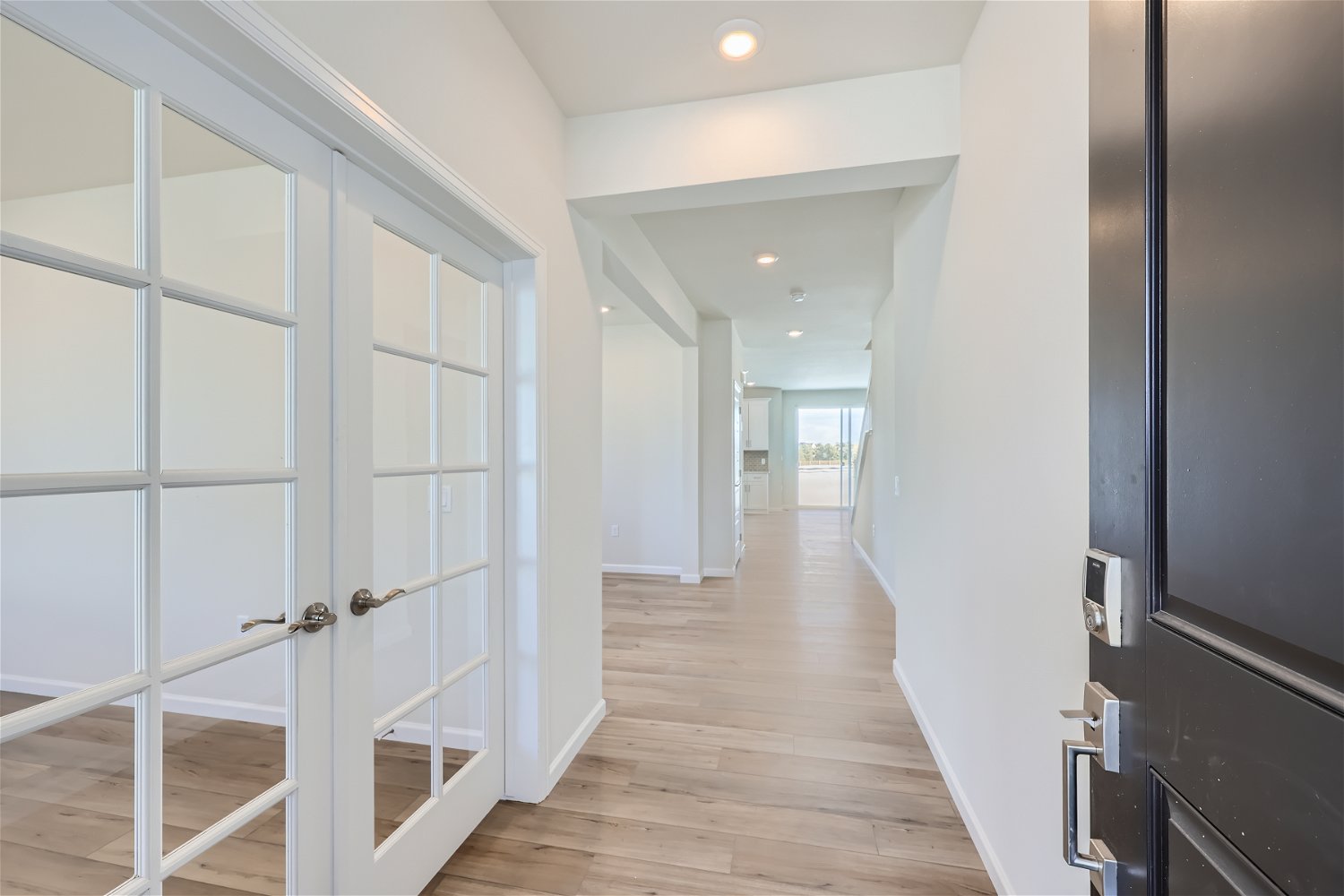 A hallway with white doors.