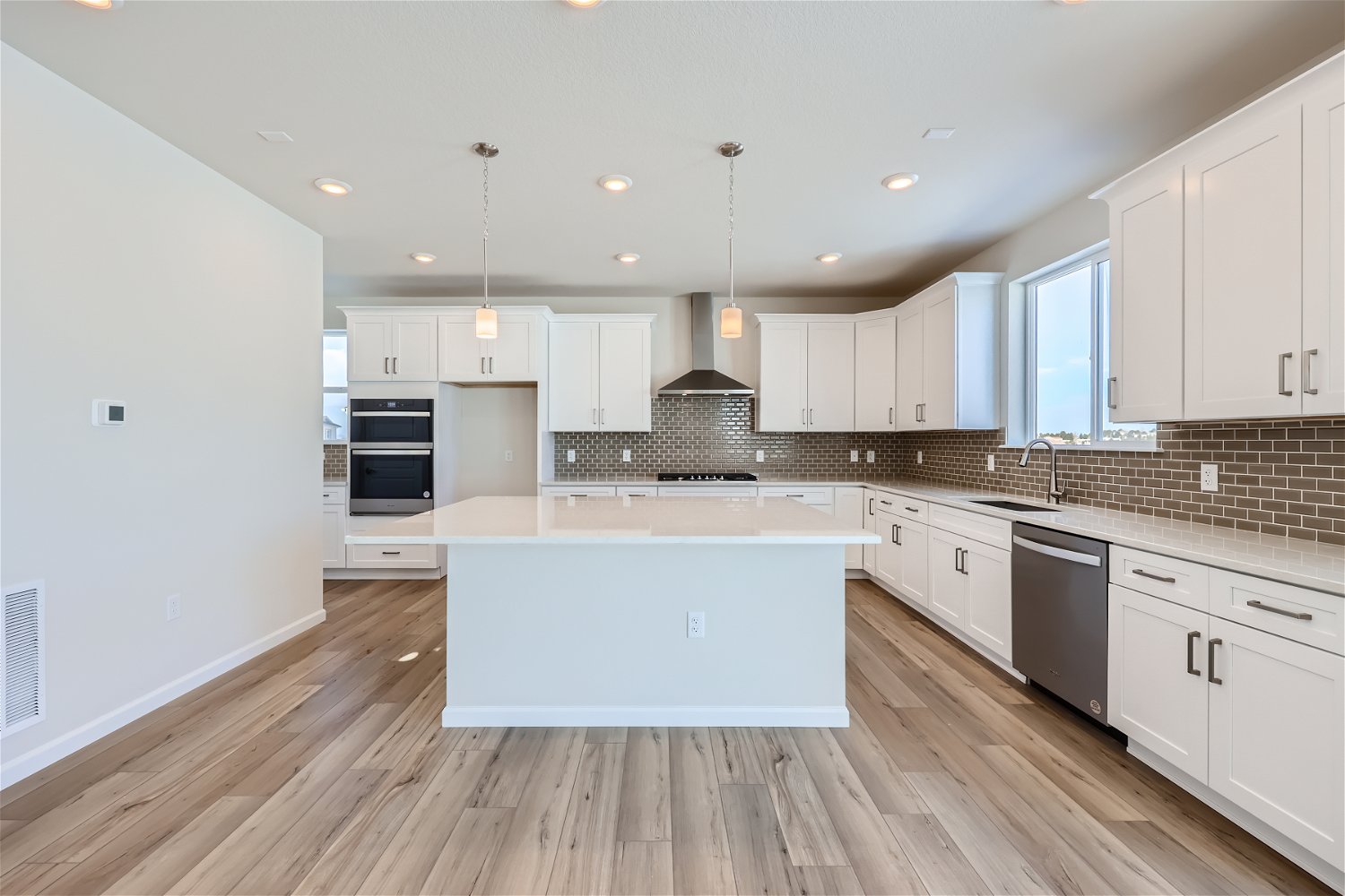 A kitchen with white cabinets.