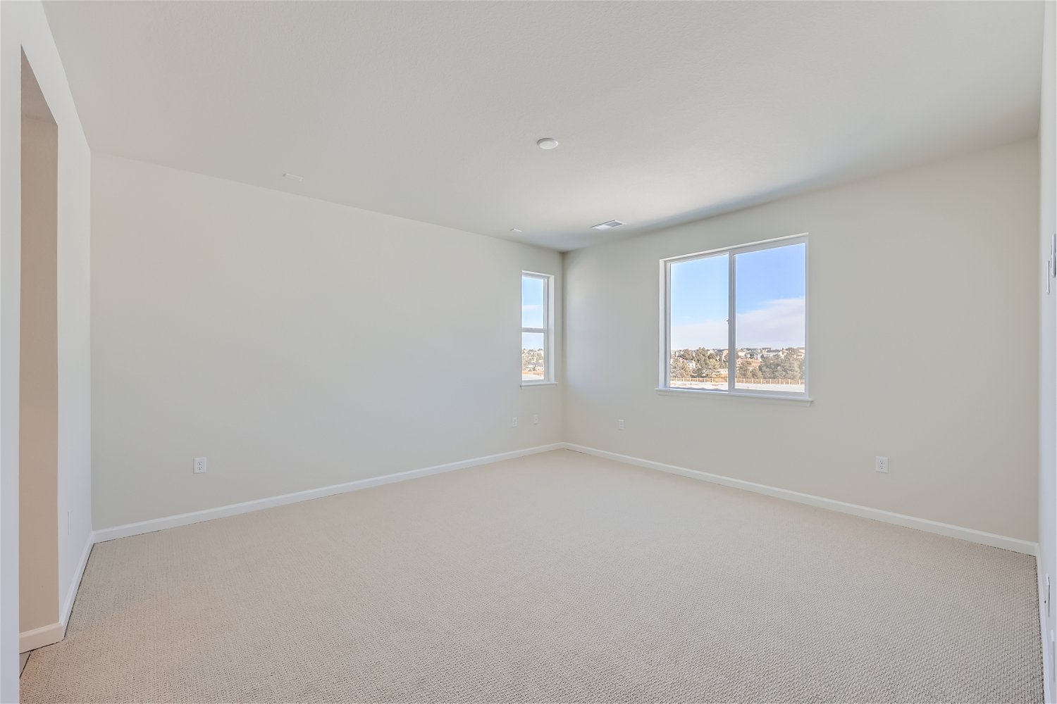 A room with a window and a carpet.