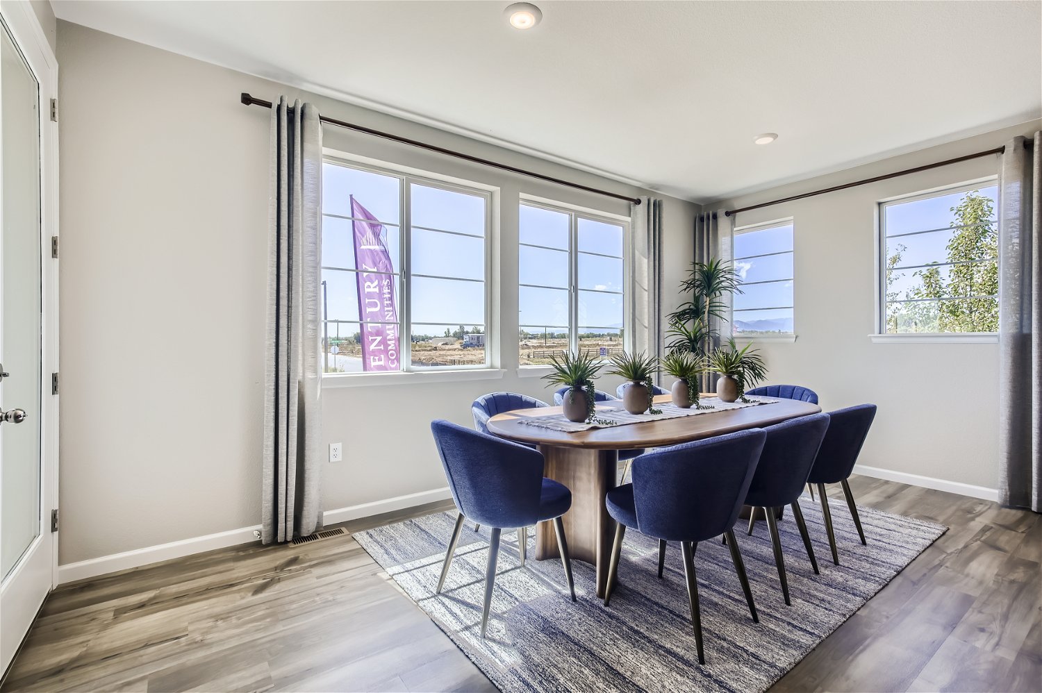 A dining room with a table and chairs.