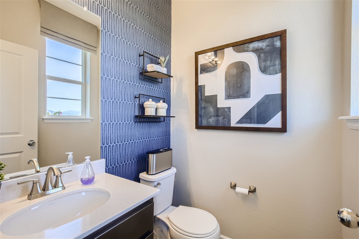 A bathroom with a blue wall.
