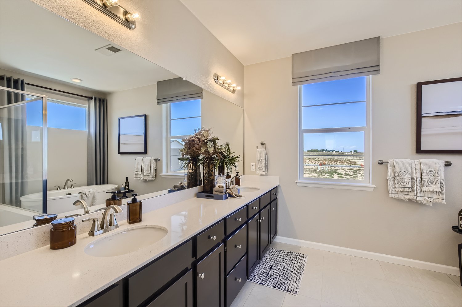 A bathroom with a large mirror.