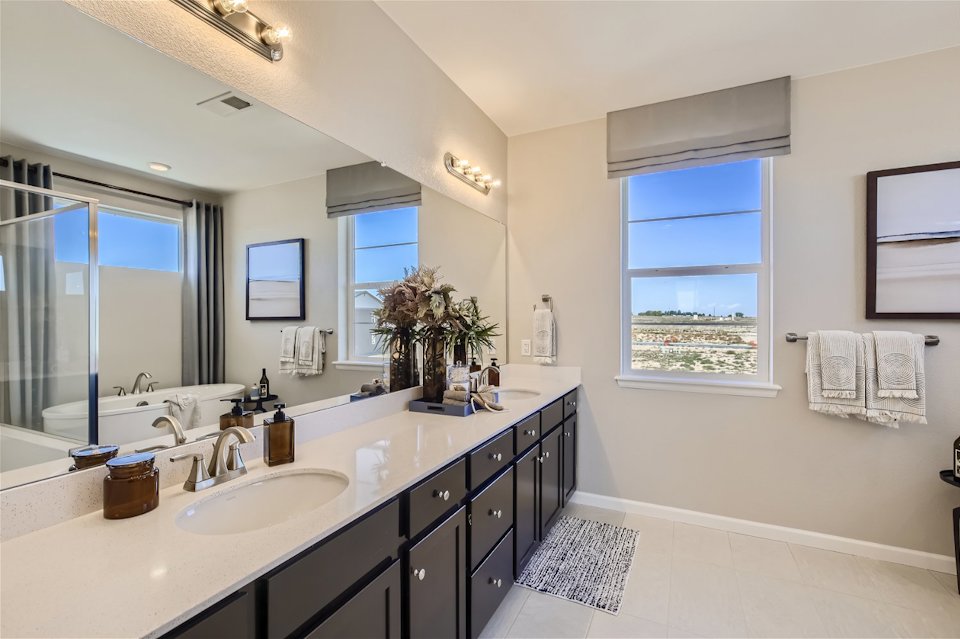 A bathroom with a large mirror.