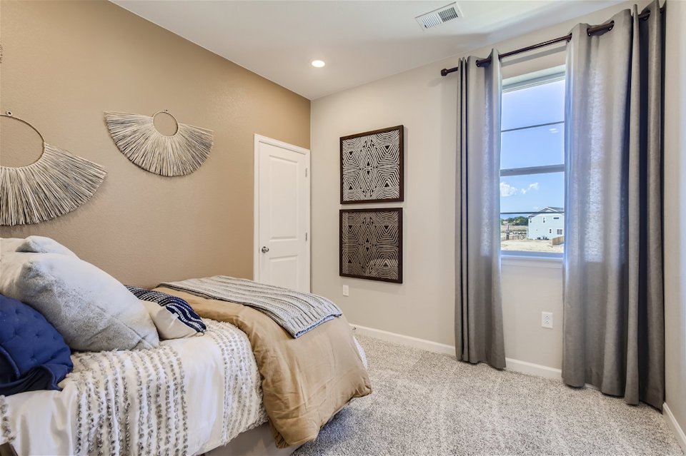 A bedroom with a large window.