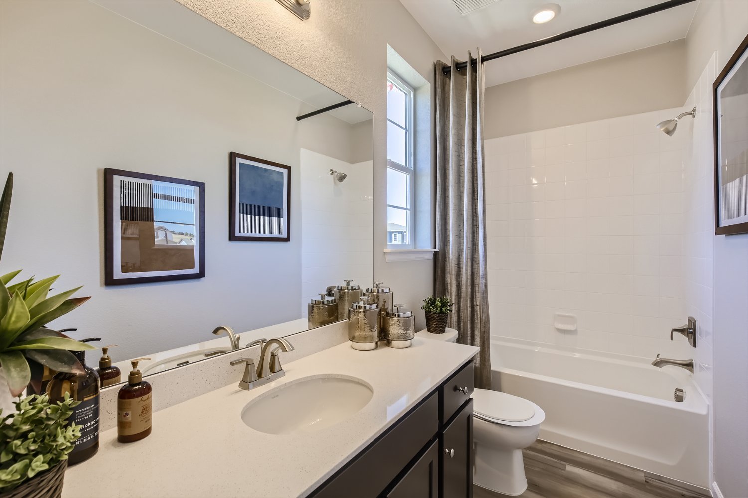 A bathroom with a tub sink and toilet.