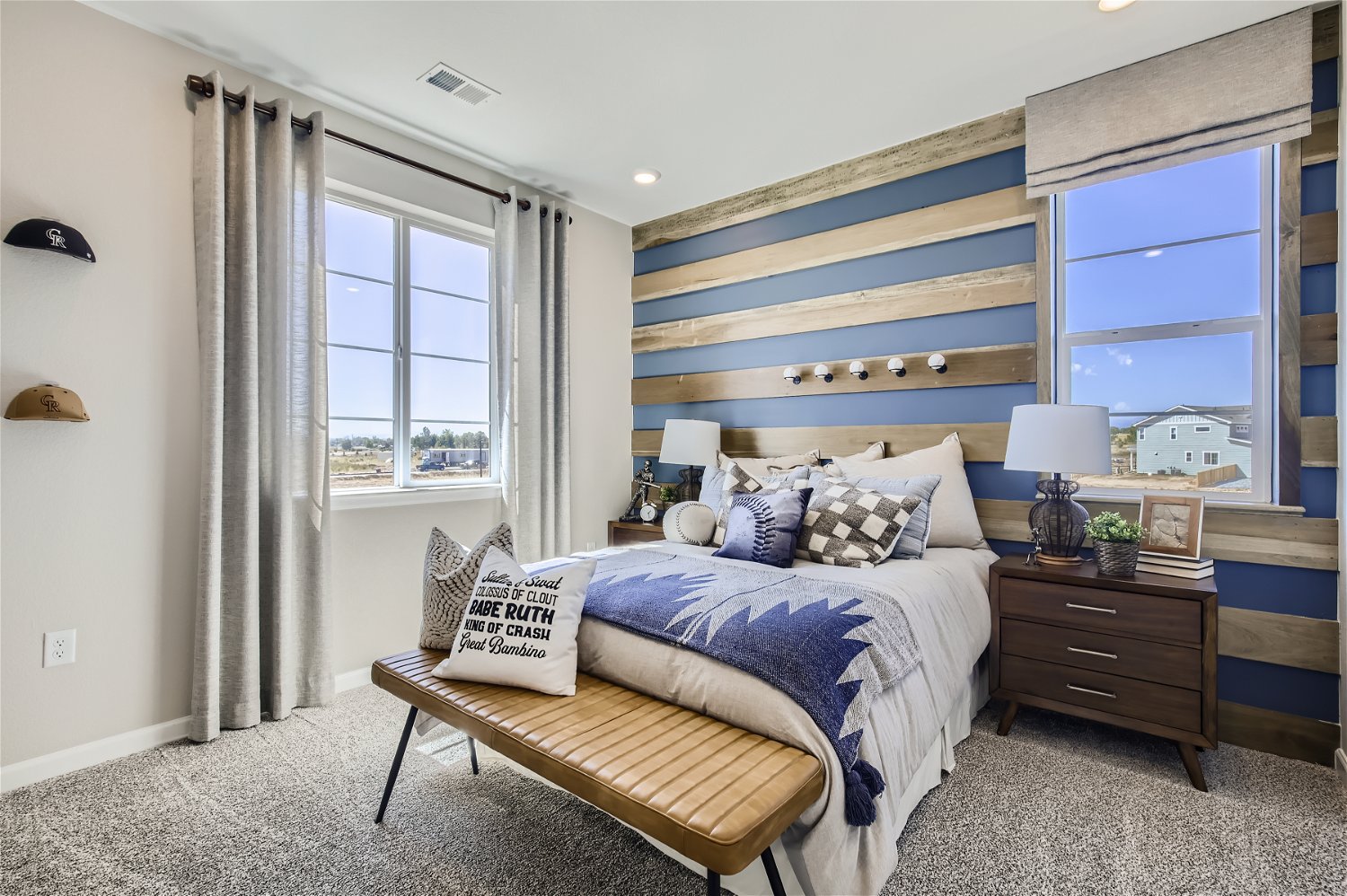 A bedroom with a bed and a bench.