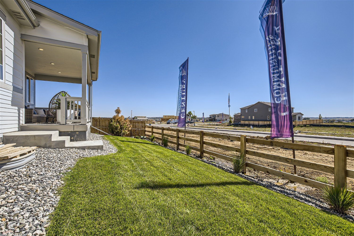 A fenced in yard with a building in the background.