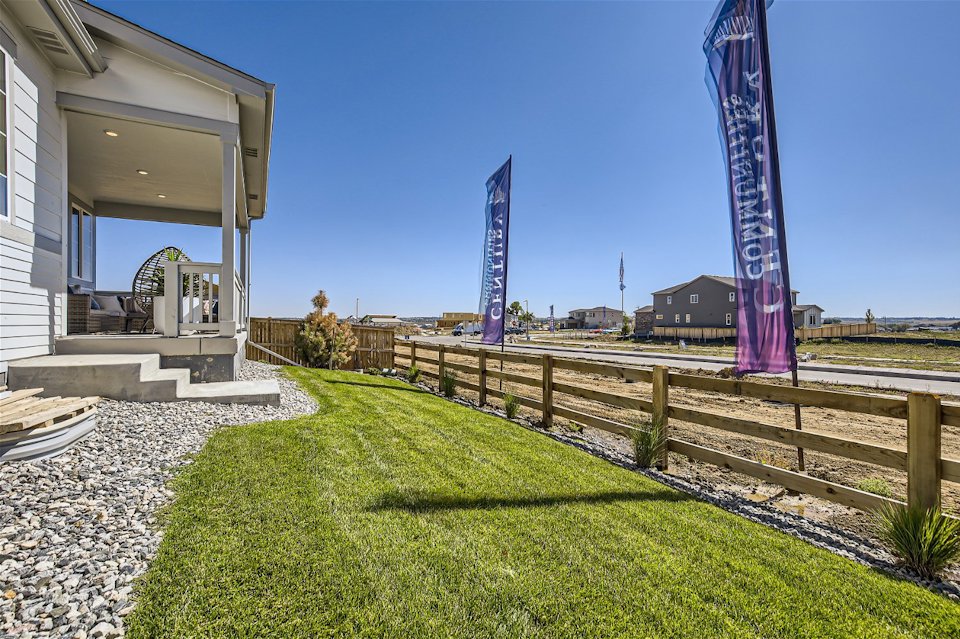 A fenced in yard with a building in the background.