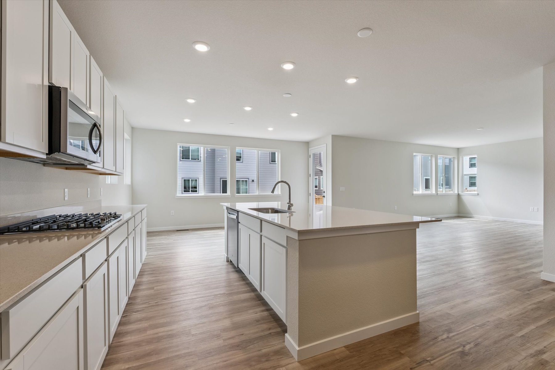 A kitchen with white cabinets.