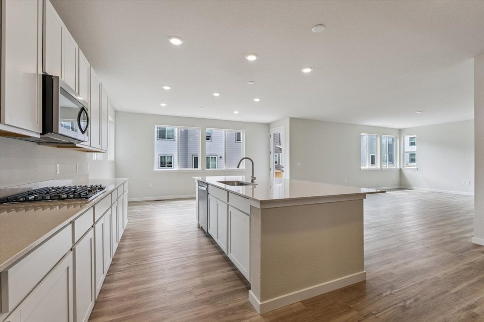 A kitchen with white cabinets.