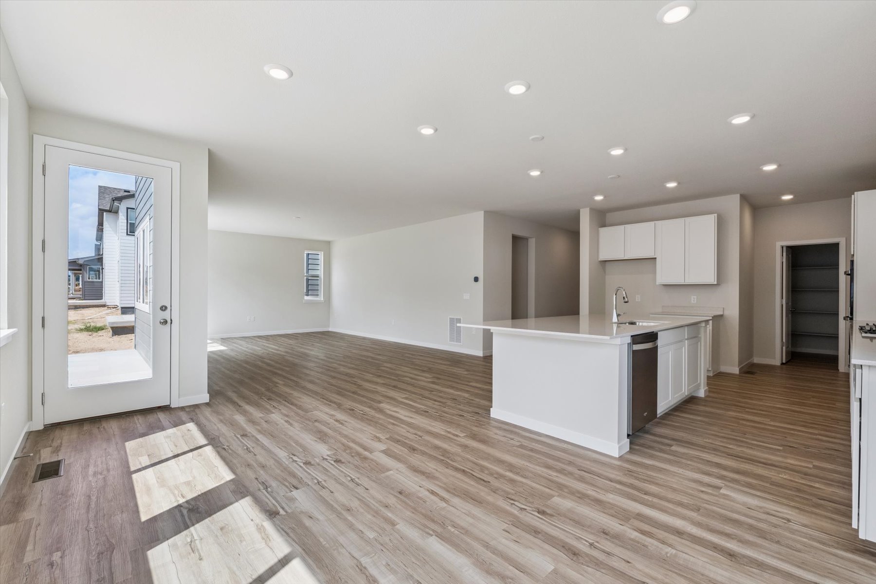 A kitchen with wooden floors.