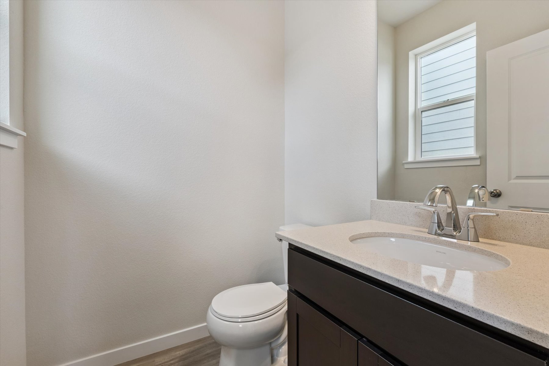 A bathroom with a sink and a toilet.