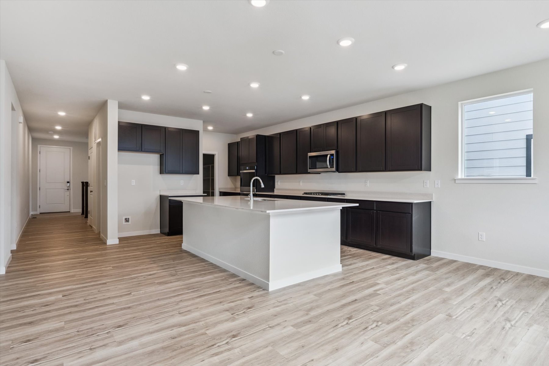 A kitchen with black cabinets.