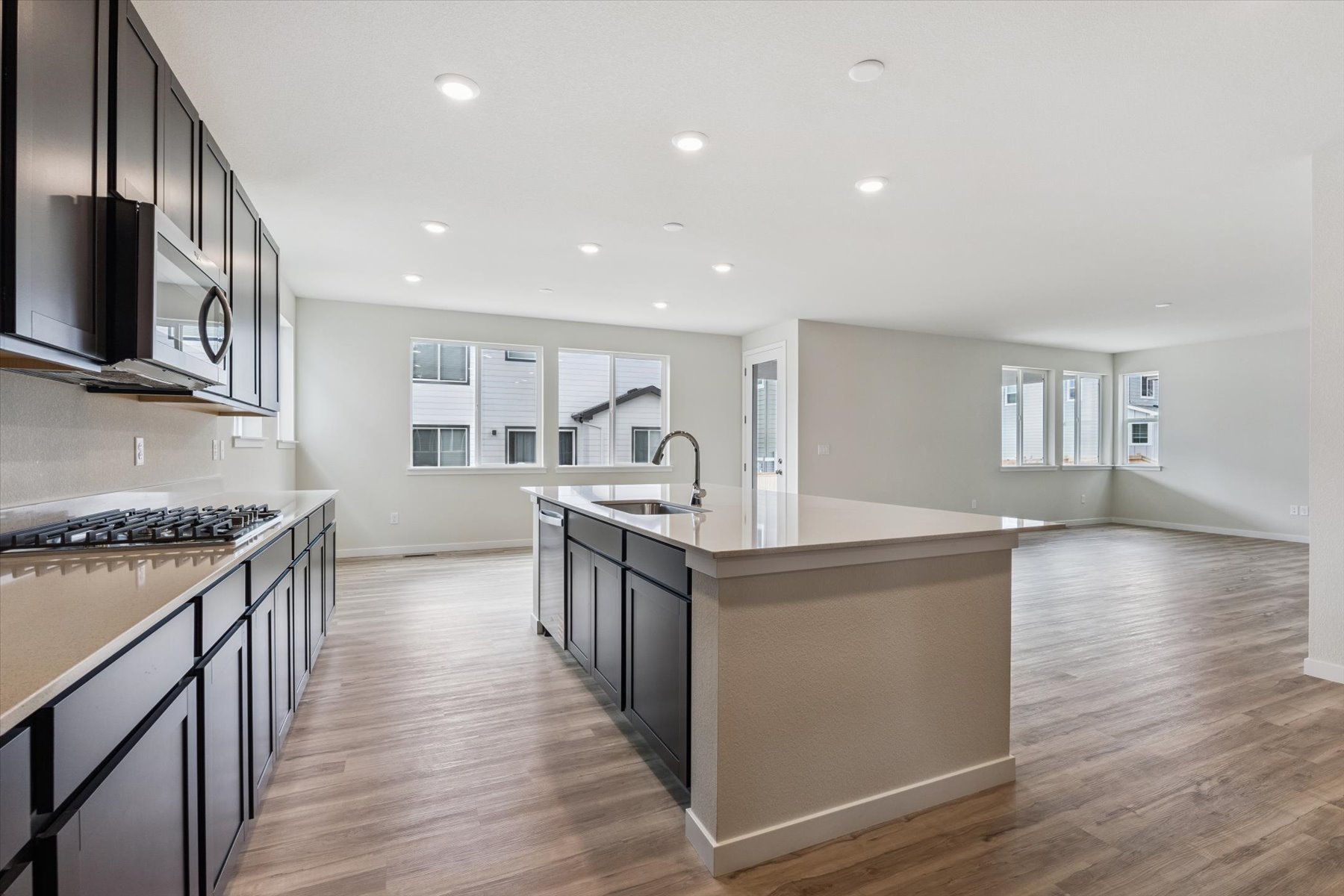 A kitchen with a wood floor.