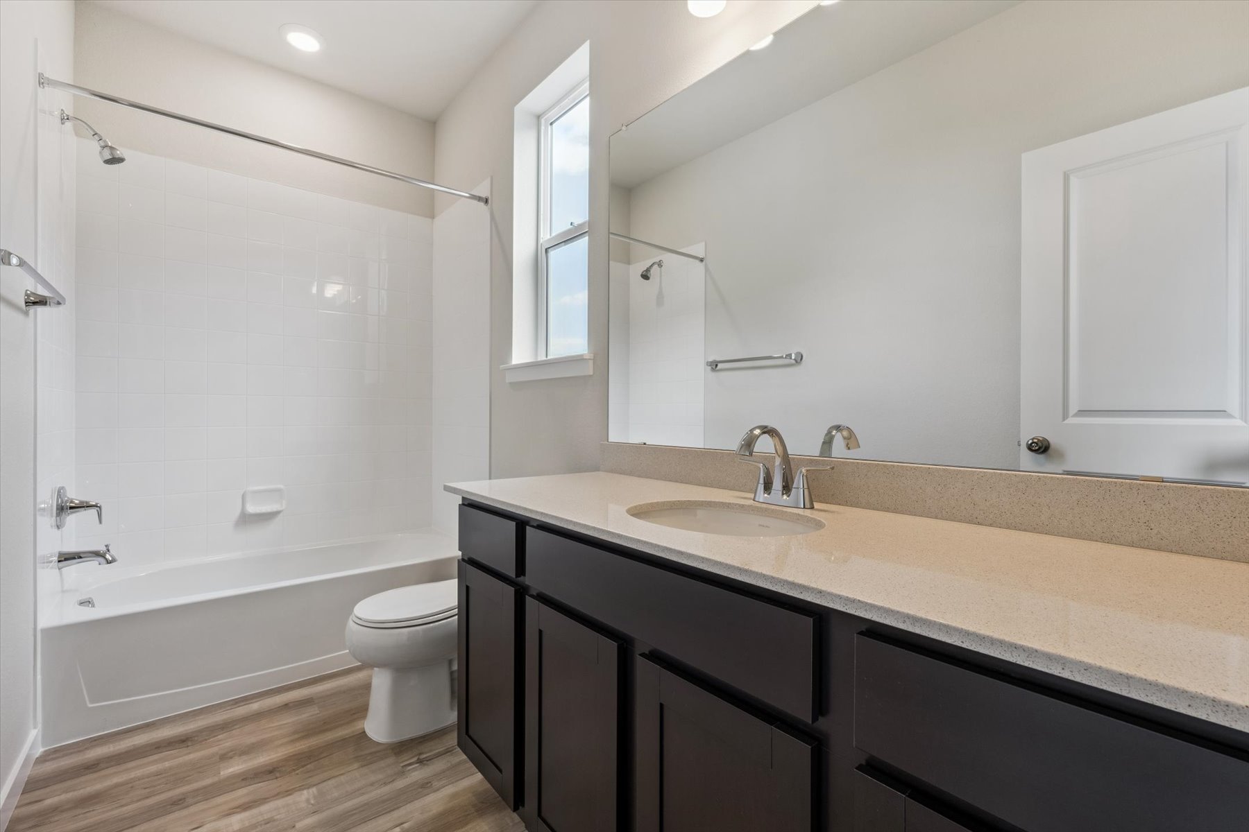 A bathroom with a tub sink and toilet.