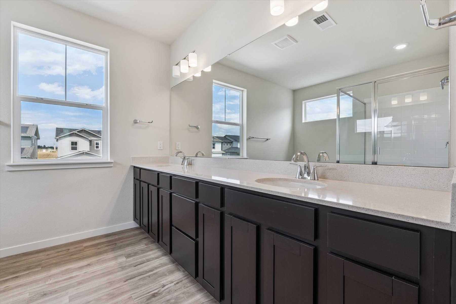 A bathroom with a large mirror.