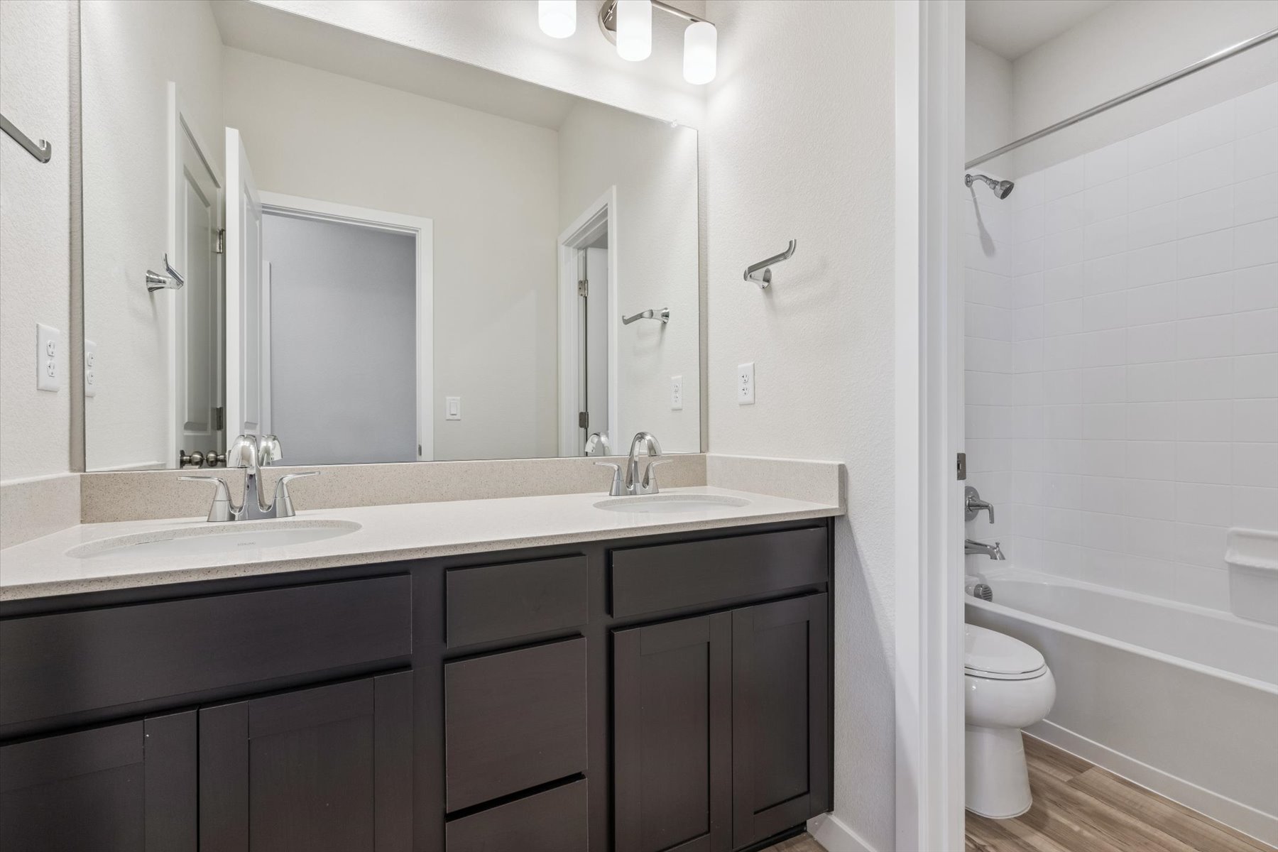 A bathroom with a tub sink and toilet.