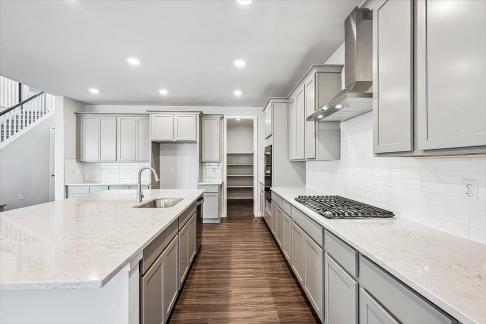 A kitchen with white cabinets.