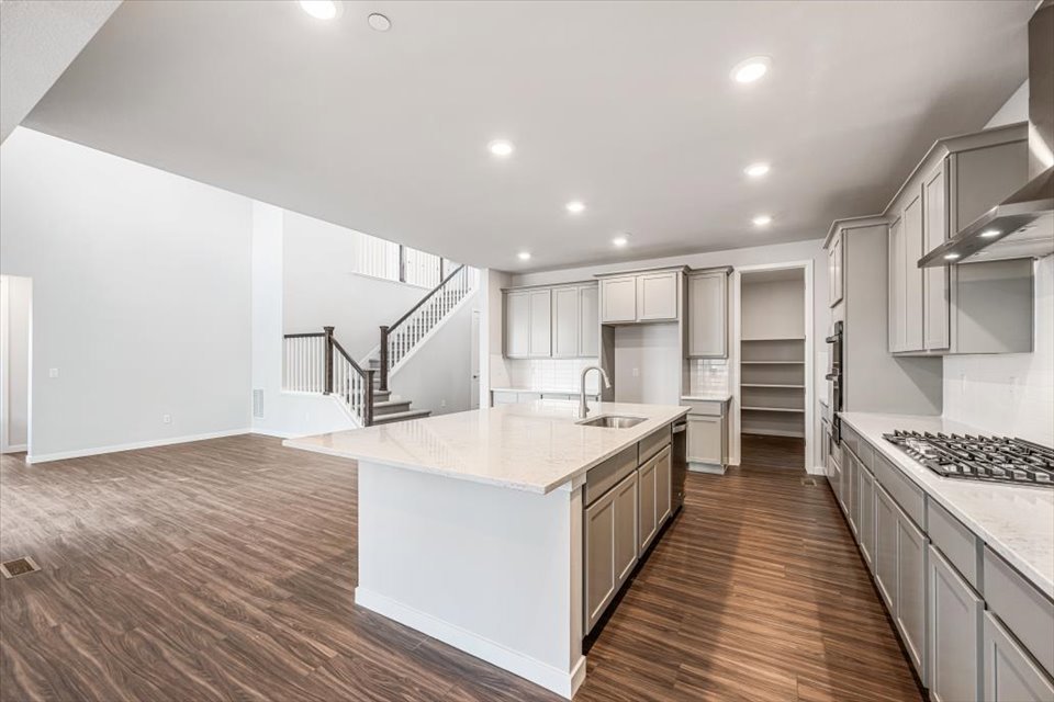 A kitchen with white cabinets.