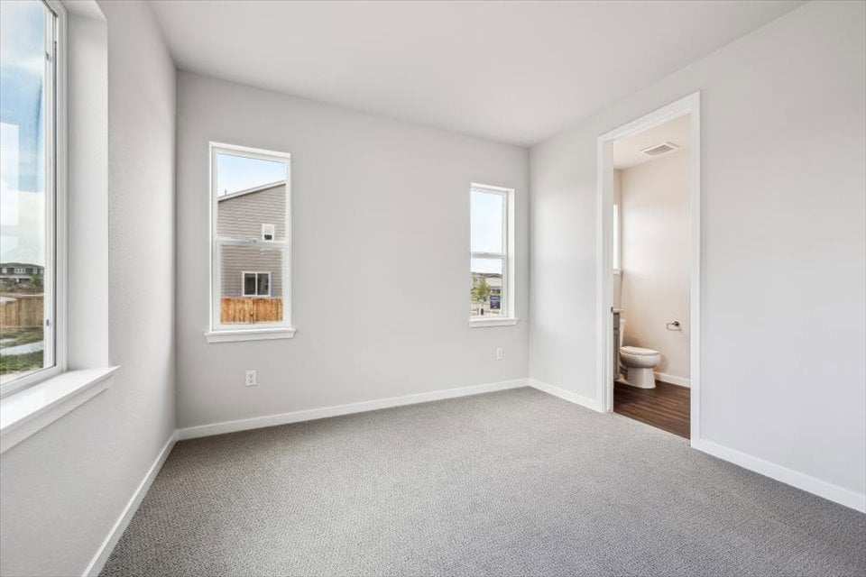 A bathroom with a toilet and a sink.