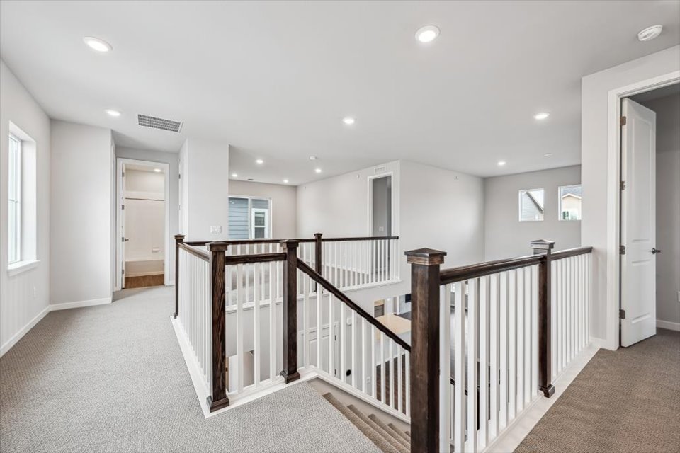 A large white house with a wood railing.