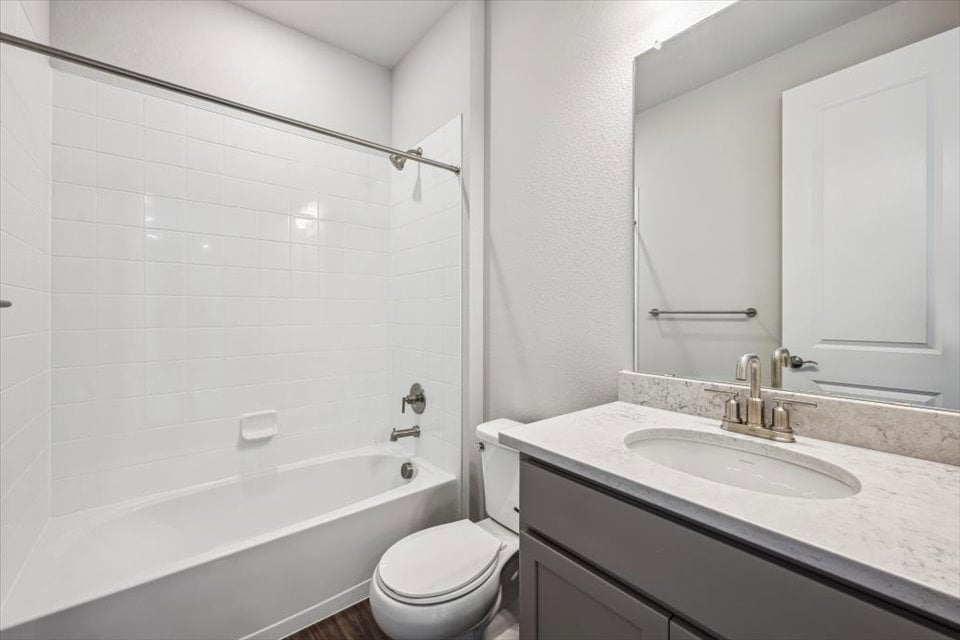 A bathroom with a sink toilet and bathtub.