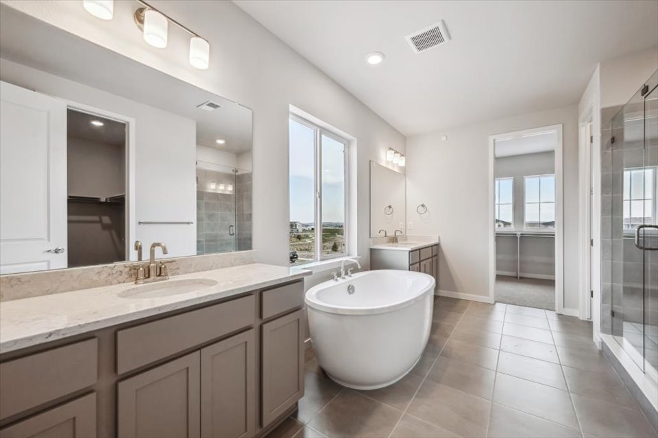 A bathroom with a tub sink and a bathtub.