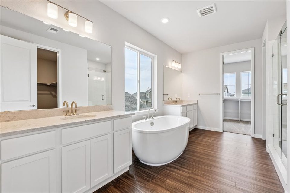 A large bathroom with a large tub.