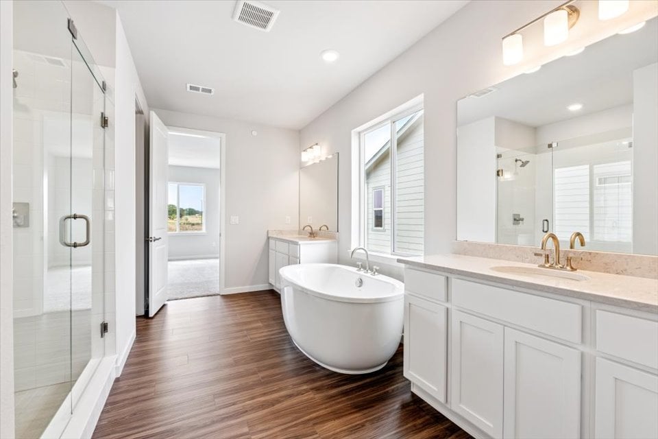 A bathroom with a tub and sink.