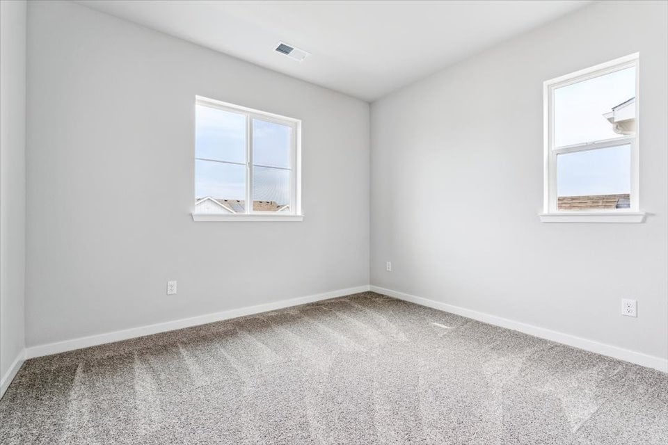 A room with a window and a carpet.