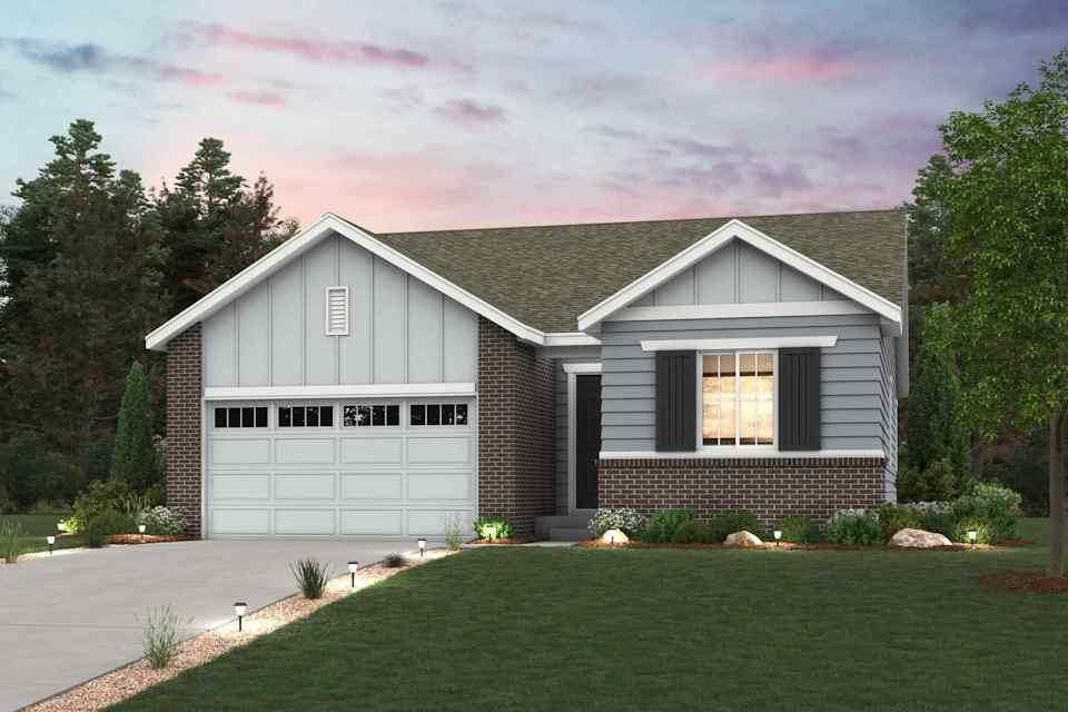 A house with a driveway and a lawn in front of it.