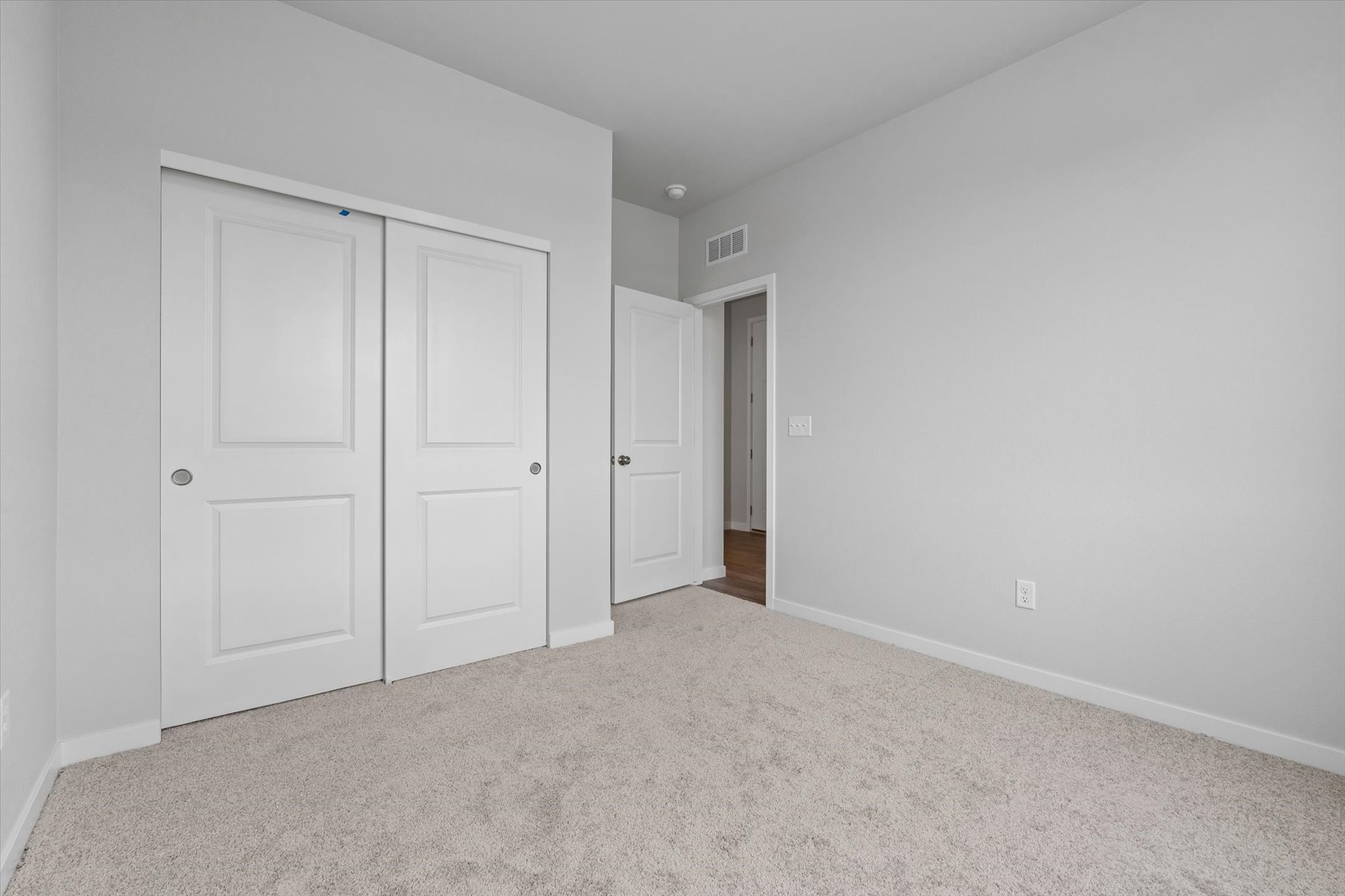 A hallway with white doors.