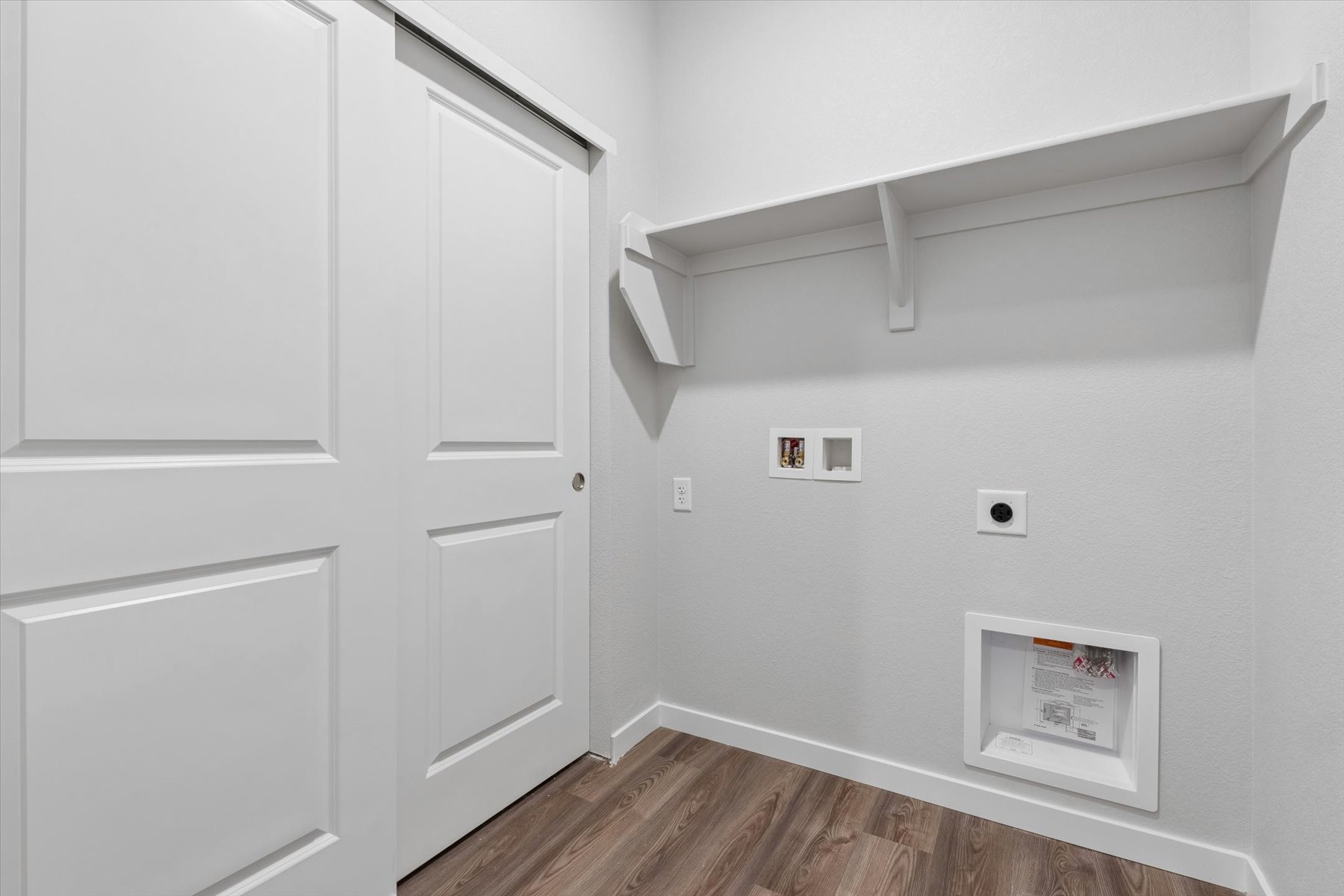 A white wall with a white door.