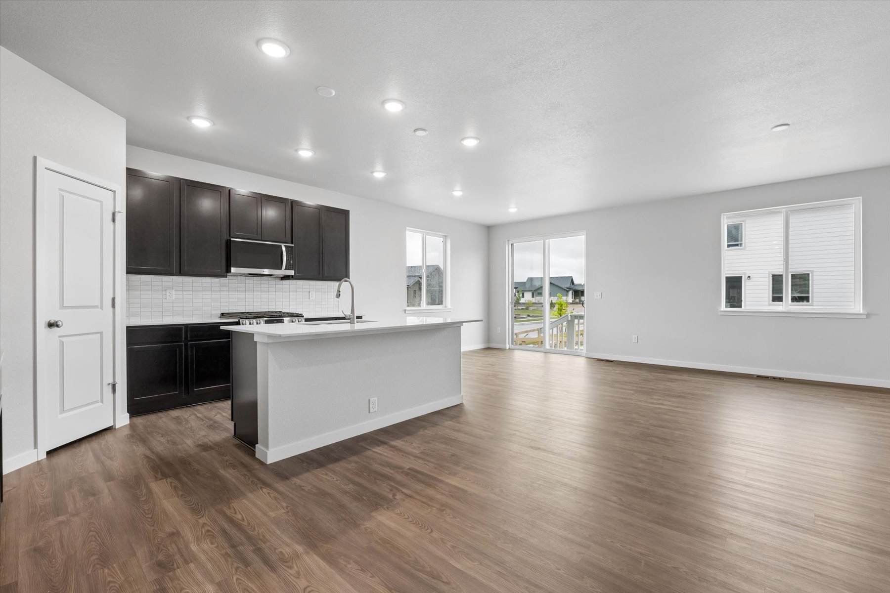 A kitchen with black cabinets.