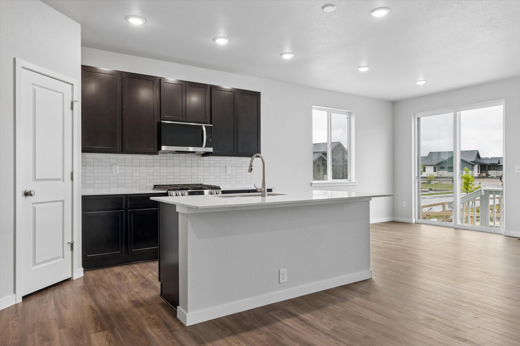 A kitchen with black cabinets.